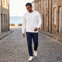 Sudadera blanca unisex Om bordado — imagen generada con IA a partir de la foto real del producto